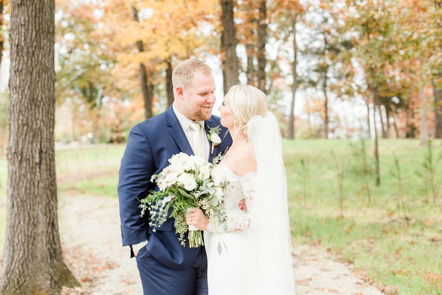 Bride and groom on fall path