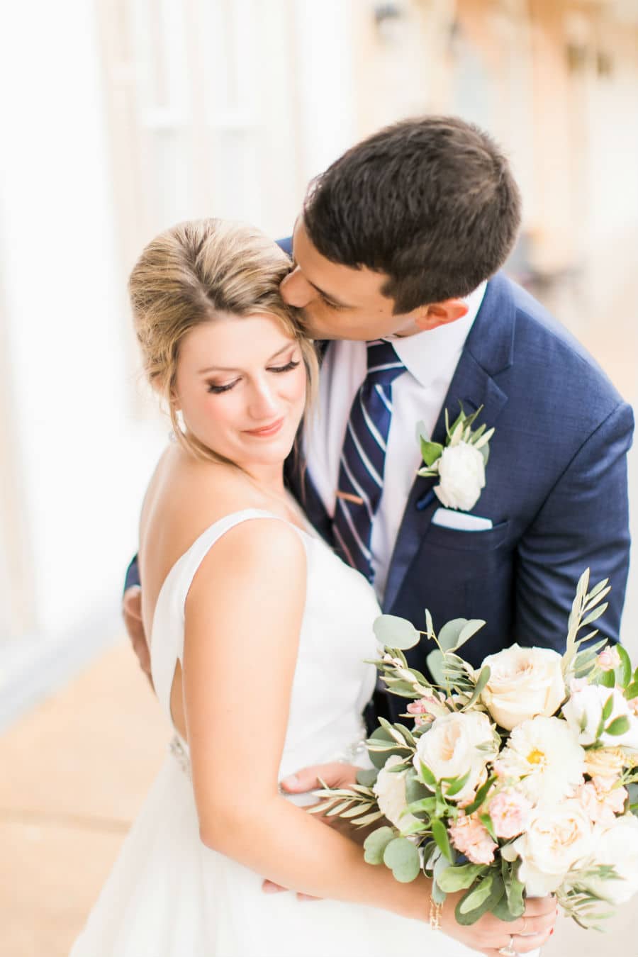 A romantic kiss from the groom