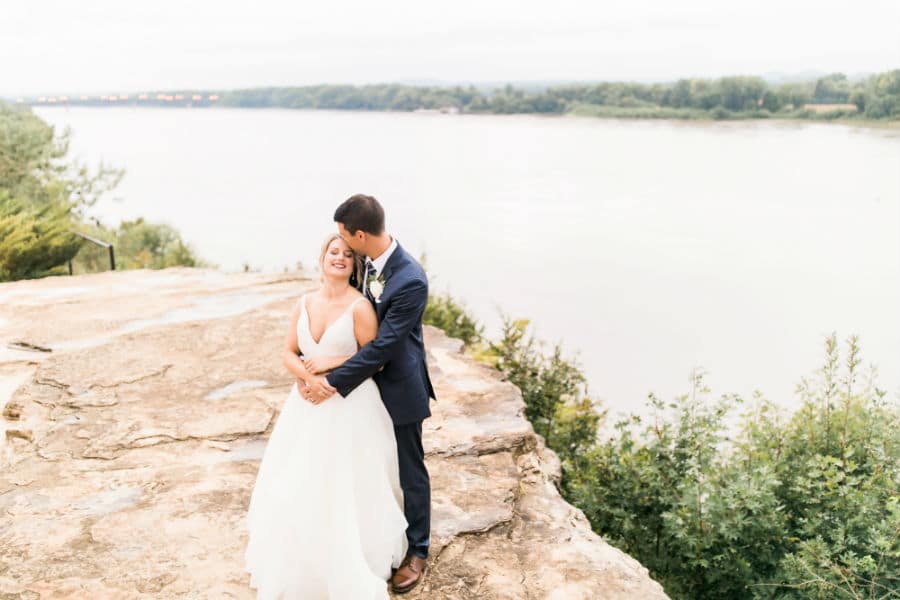 Bride and Groom embrace on our River Bluff