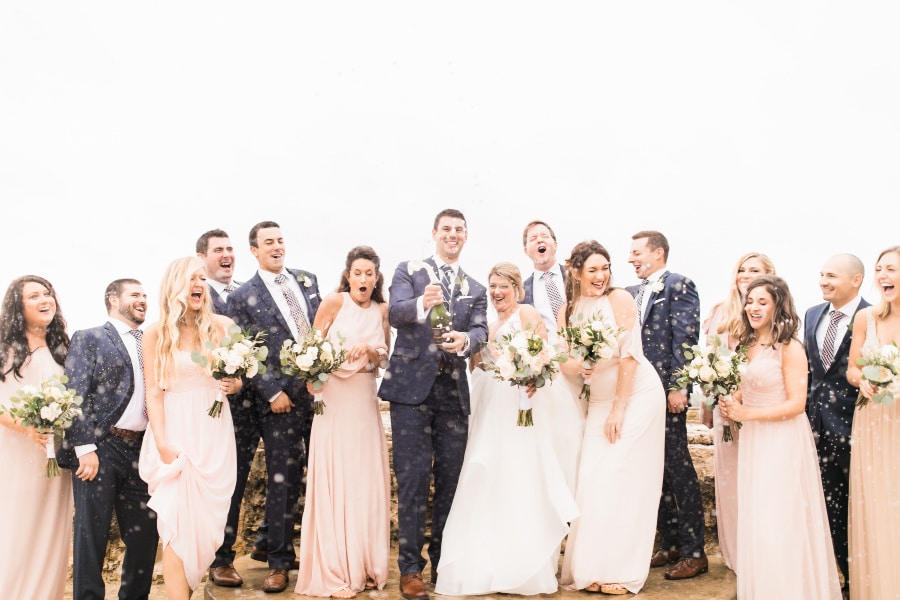 Hermann Hill Wedding Packages: Bridal Party celebrating with confetti poppers on the river