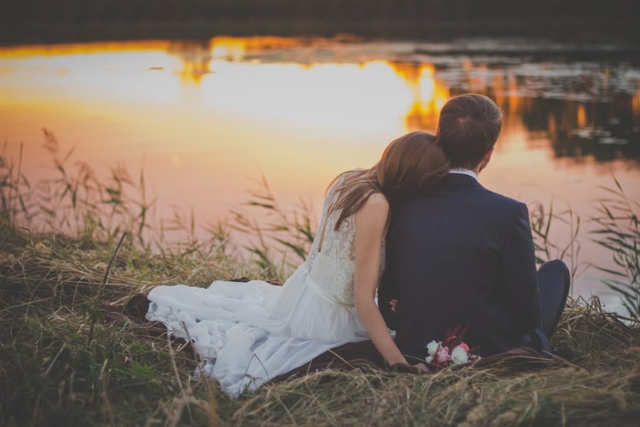 Bride and groom watching the sunset on the Missouri river at Hermann Hill Wedding Venue