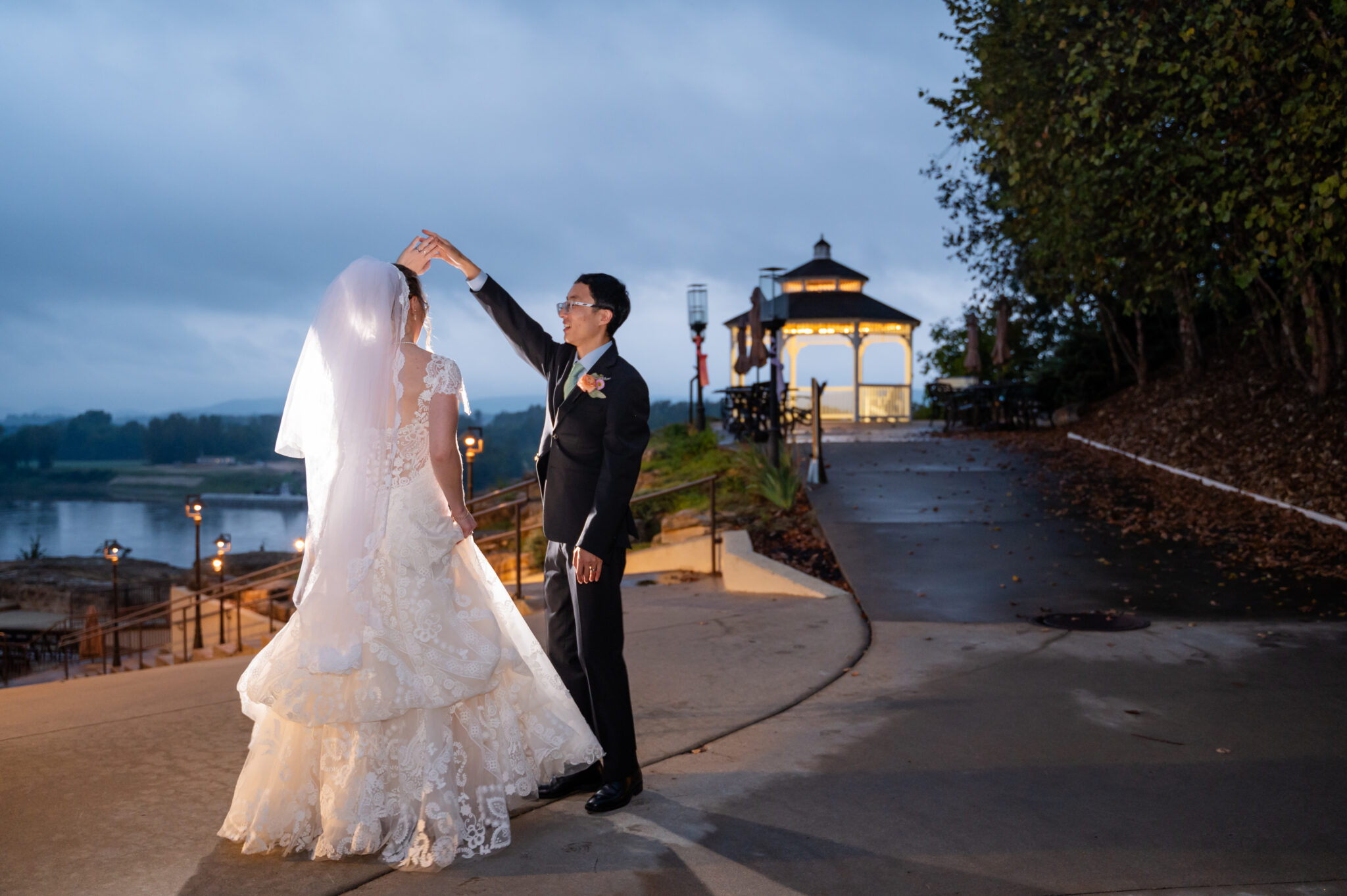 bride and groom at night near gazebo