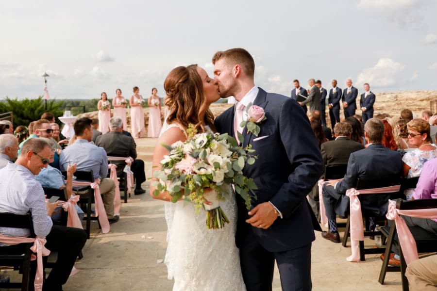 Bride and groom kiss at ceremony