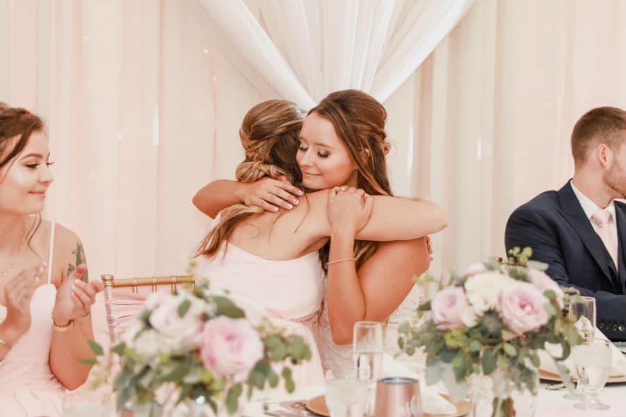 Bride hugging maid of honor