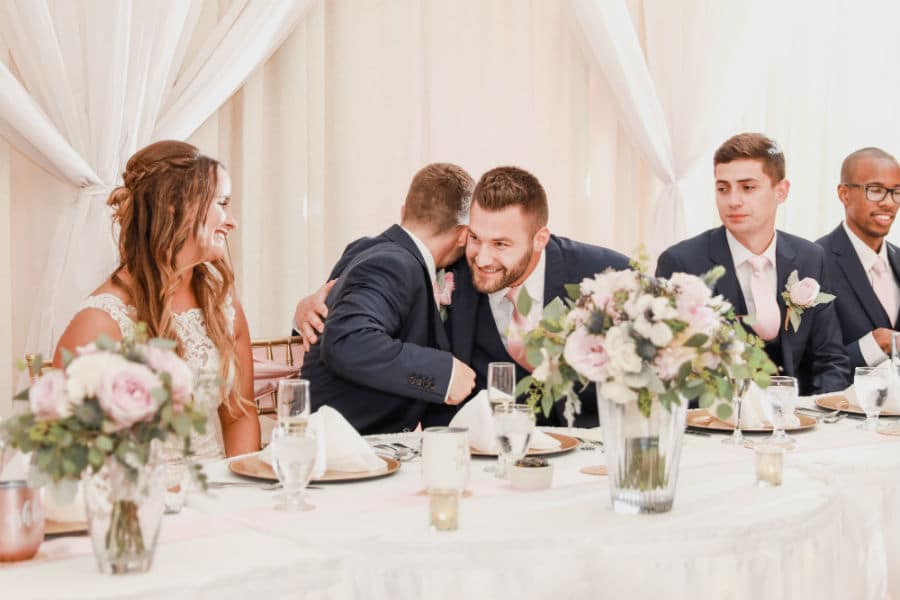 Groom hugging the best man